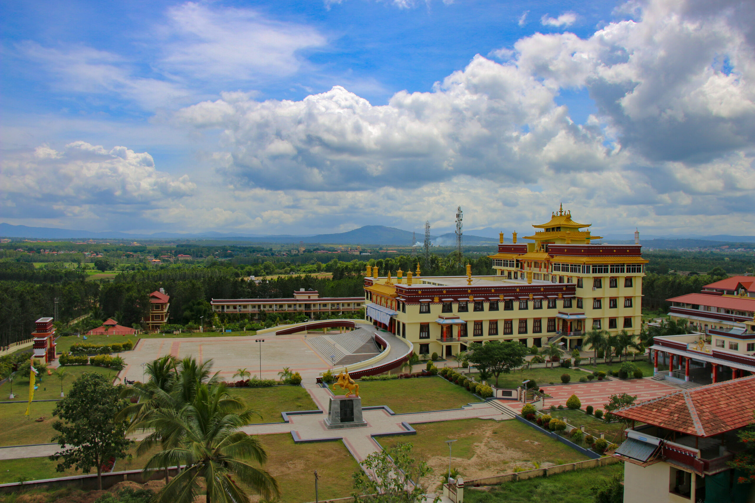 A wide view of the main tashi lhunpo temple under a cloudy sky.