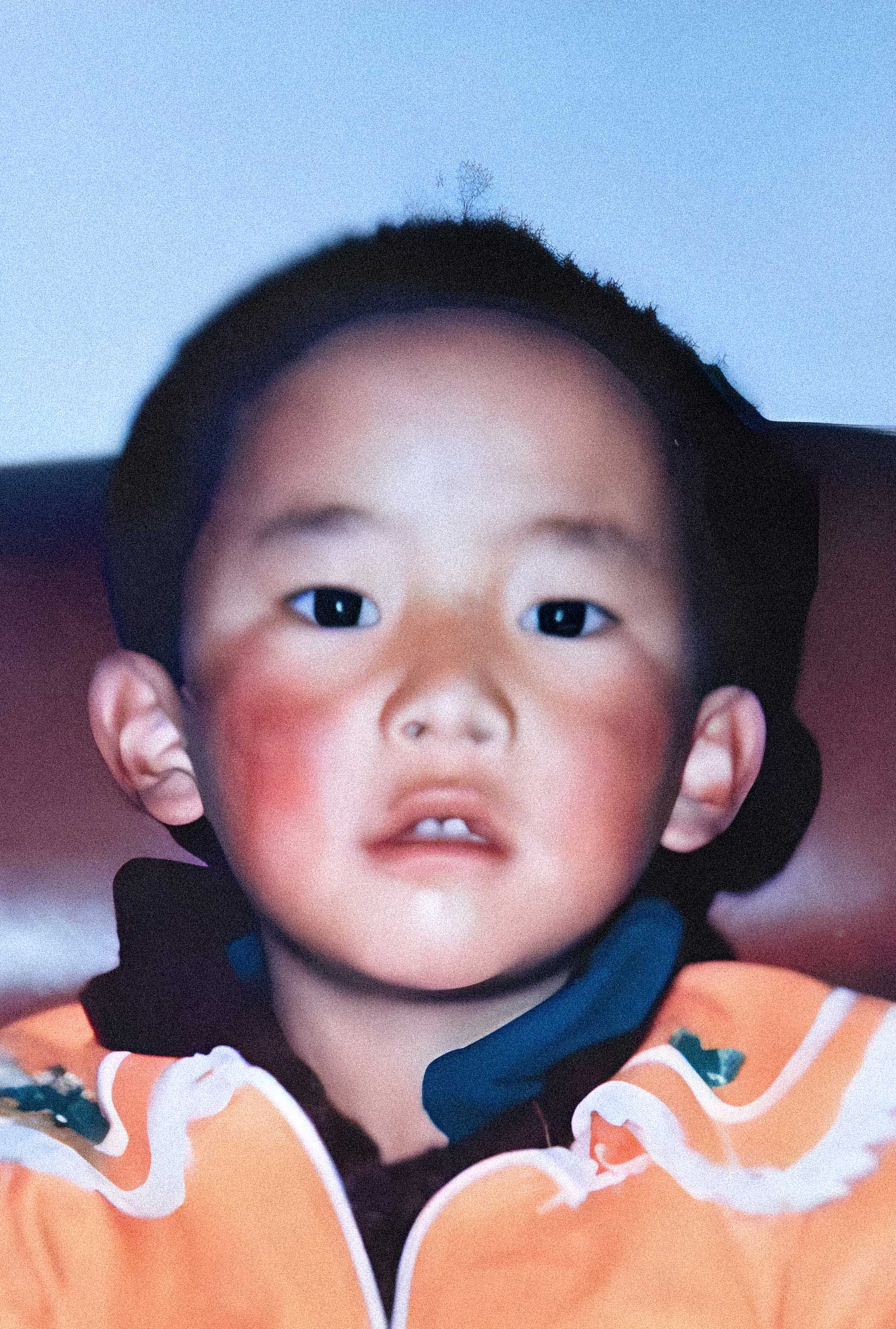 A close-up of a young Gedhun Choekyi Nyima the 11th Panchen Lama looking directly at the camera.