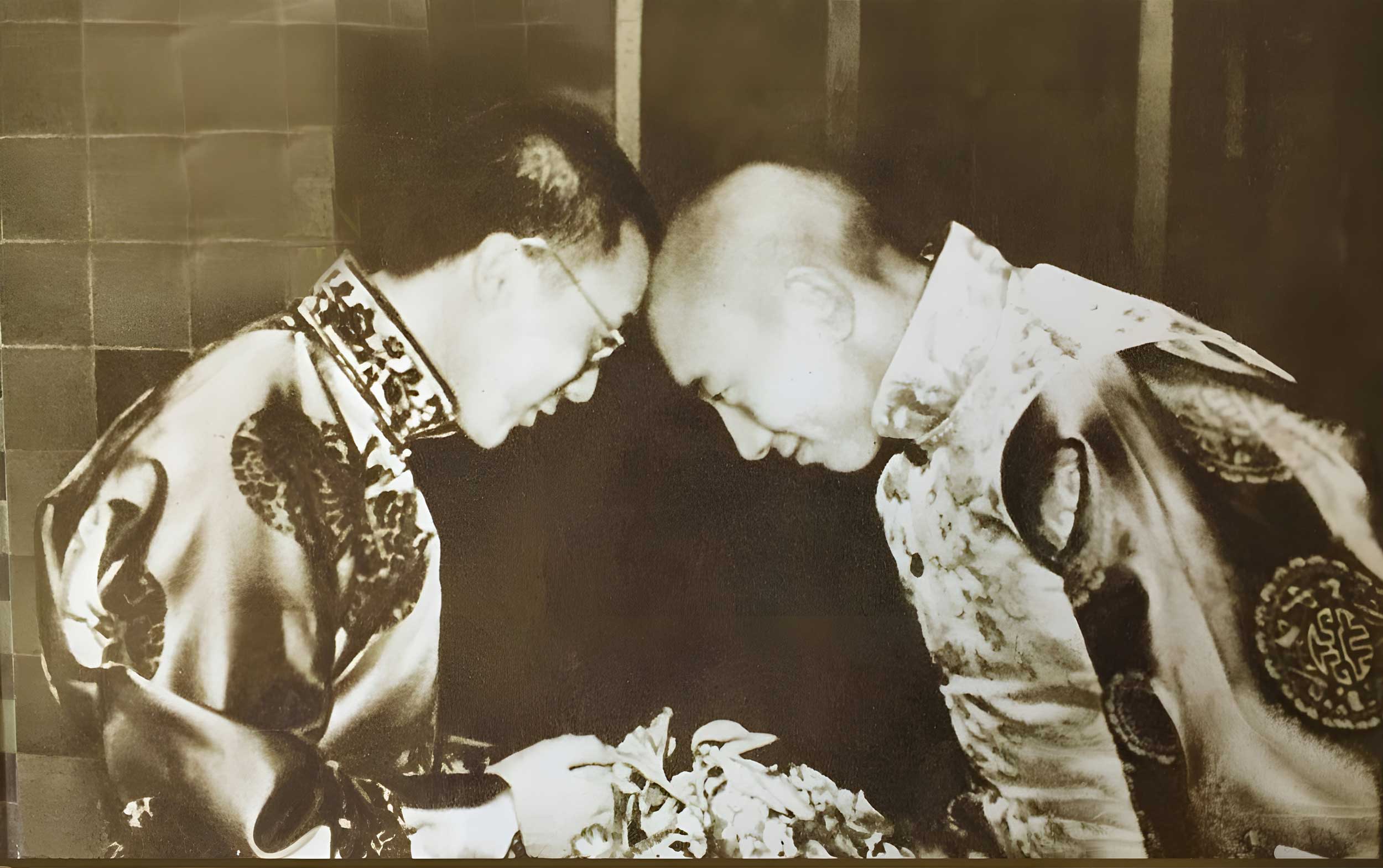 Vintage photo of His Holliness the Dalai Lama meeting the panchan lama with their heads touching.