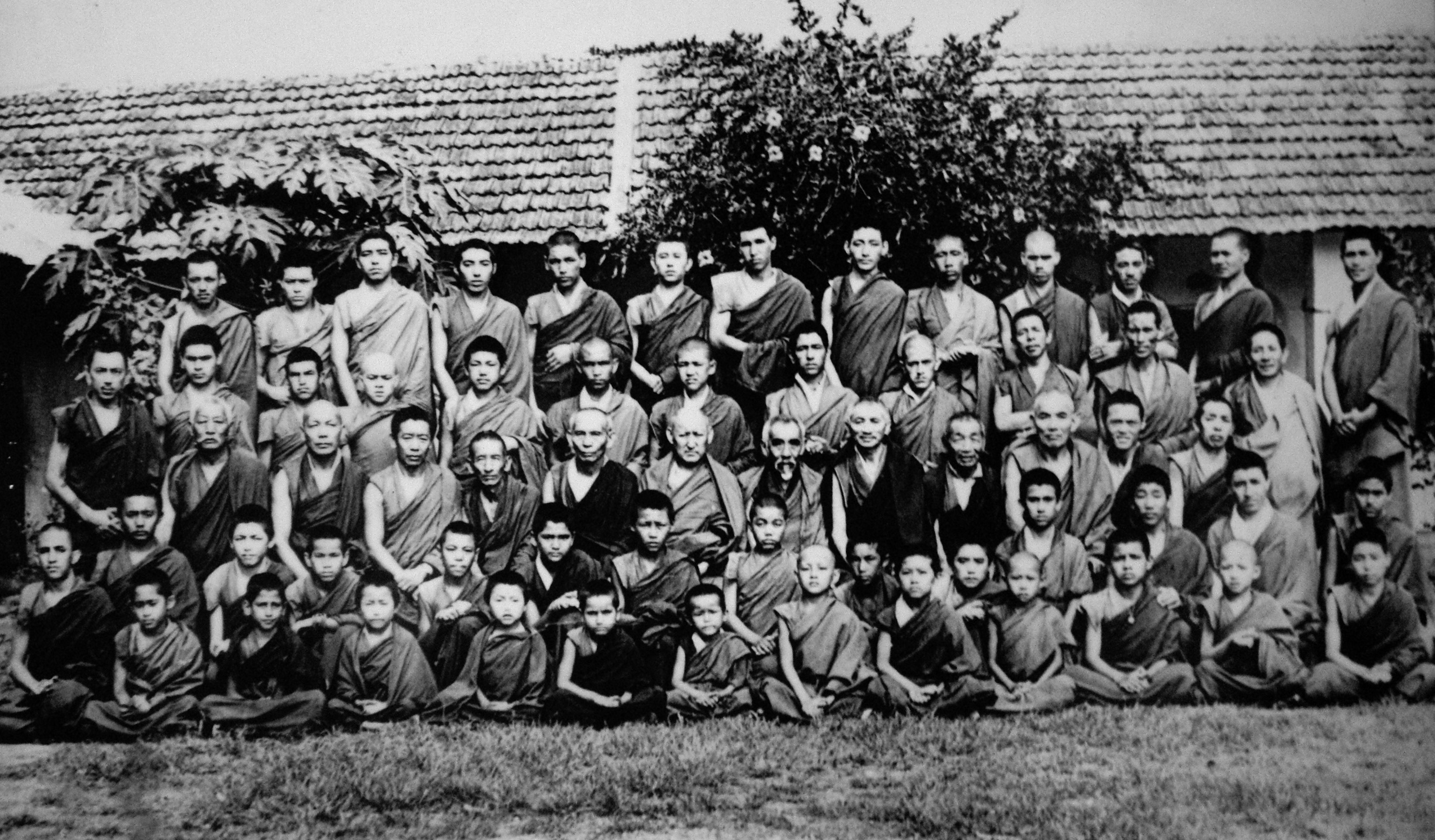 Large black and white historical group portrait of monks in exile.