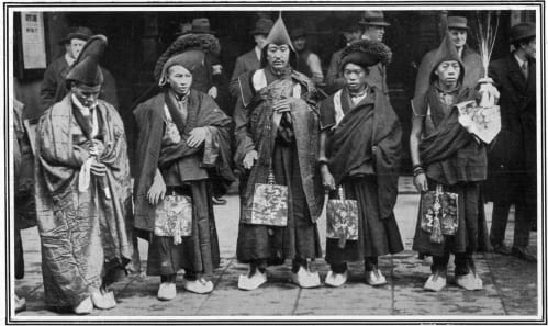 Vintage photo of group of people in traditional Tibetan attire.