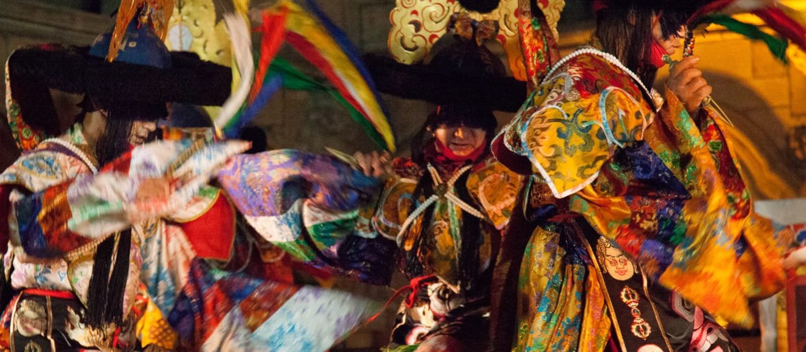 Tashi lhunpo monks dancing in their masked dance outfits.
