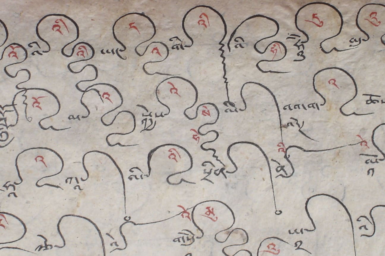 Traditional Tibetan Uchen script on paper.