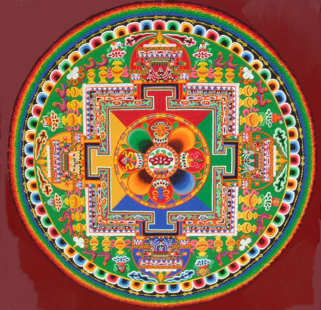 A detailed, multi-layered circular sand mandala.