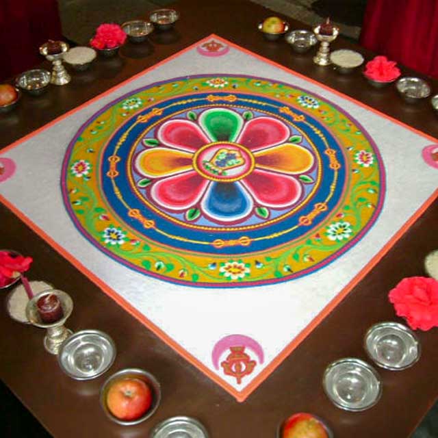 A finished, intricate sand mandala in a square frame.